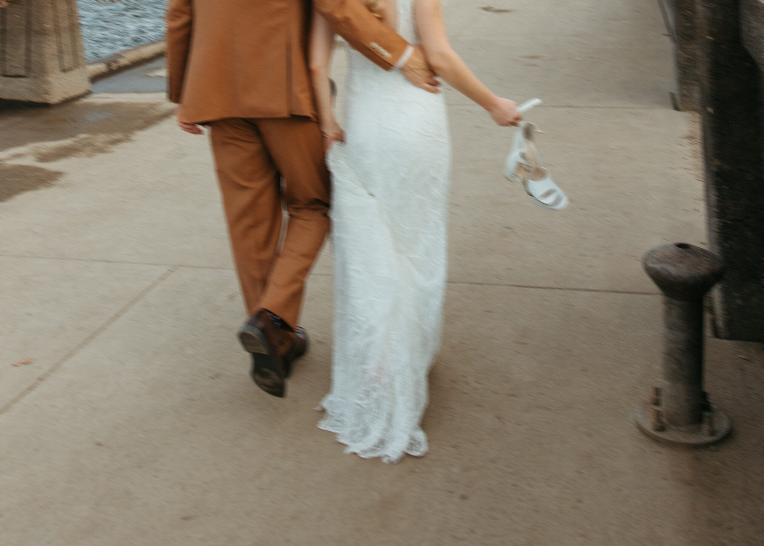 Wedding couple posing on the Stillwater Lift Bridge with the historic downtown buildings and Loft 214 visible in the background