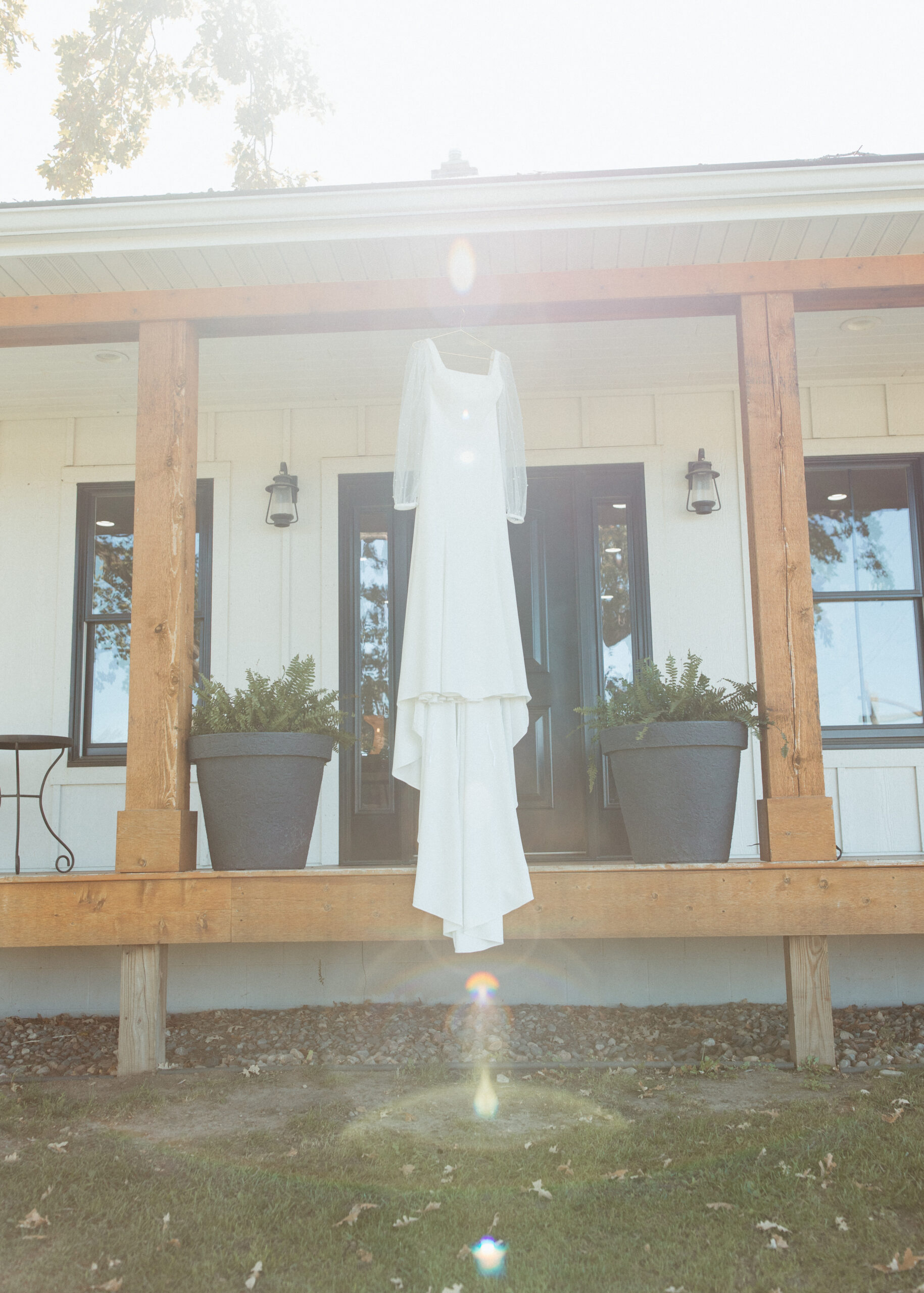 A stunning long-sleeve pearl bridal gown styled by D'Amore Wedding and Event Planning, featured in a professional Minneapolis wedding photography gallery.
