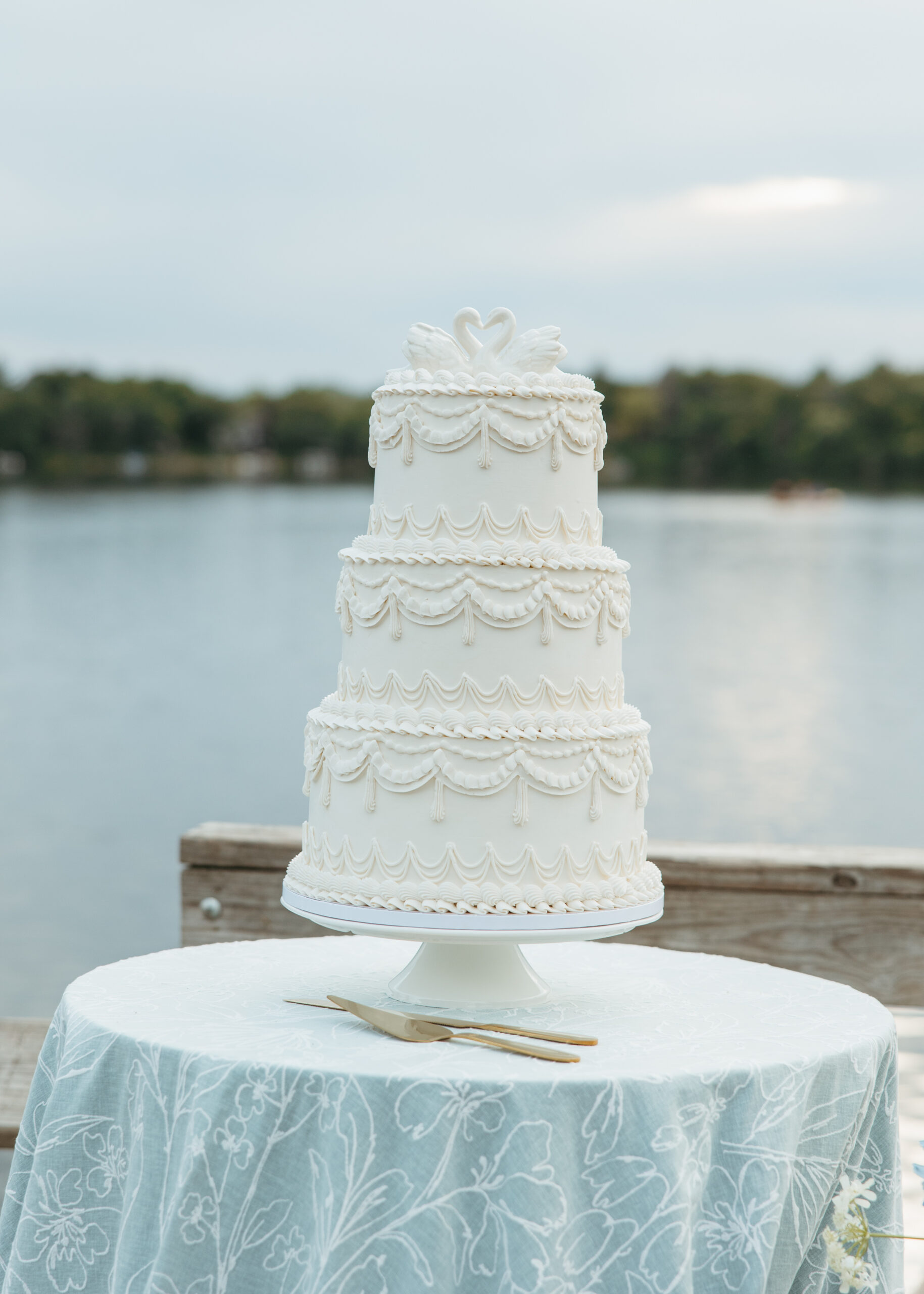 Coastal inspired lakeside wedding table setup with soft blue linens and white floral arrangements for a Minneapolis wedding.